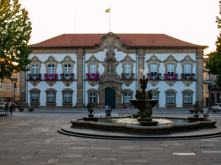Historic Braga city center with fountain at sunset