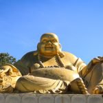 Massive golden Buddha statue at Buddha Eden garden, Portugal