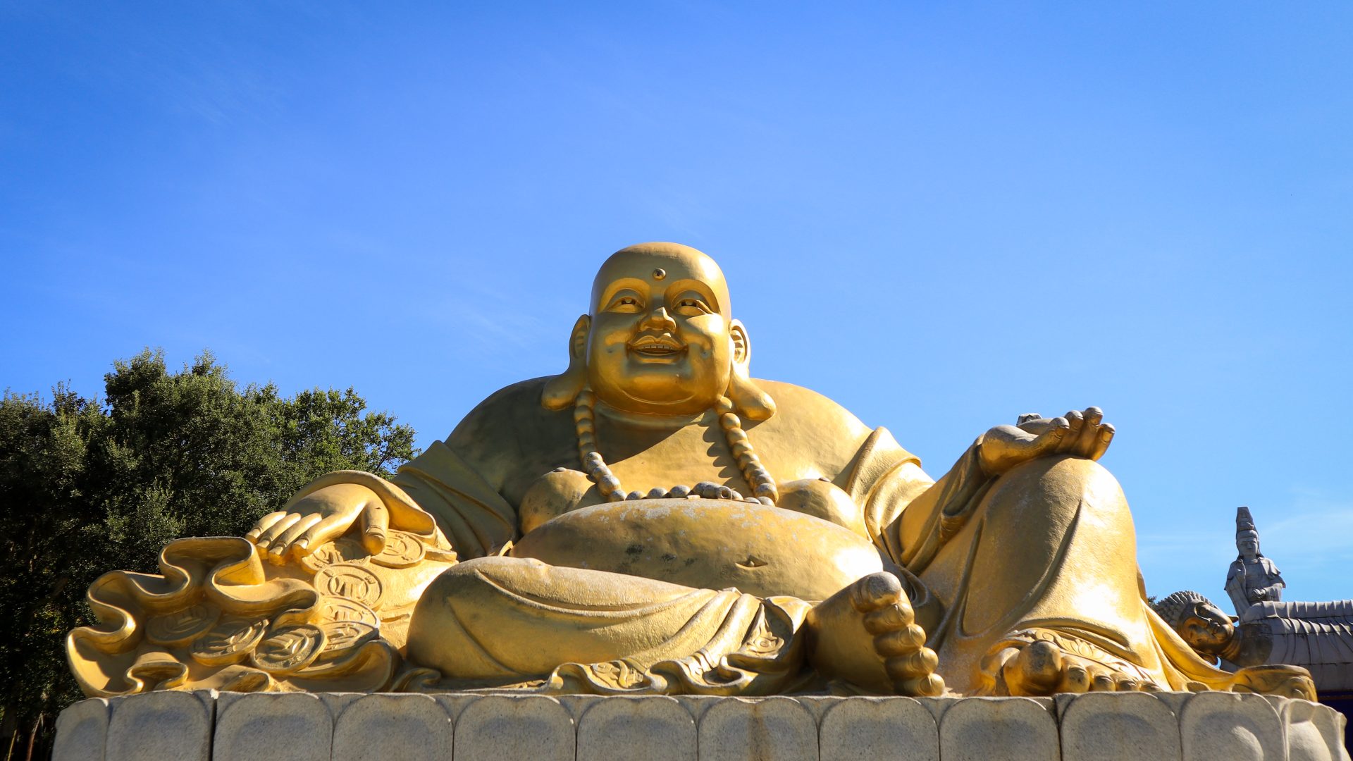Massive golden Buddha statue at Buddha Eden garden, Portugal