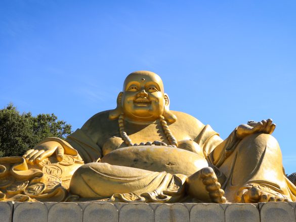Massive golden Buddha statue at Buddha Eden garden, Portugal