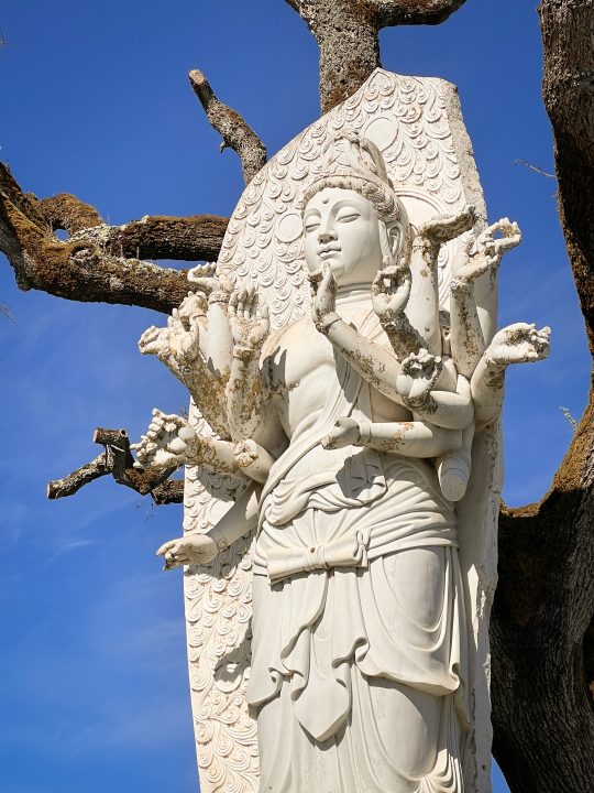 Close-up of white multi-armed Buddhist statue