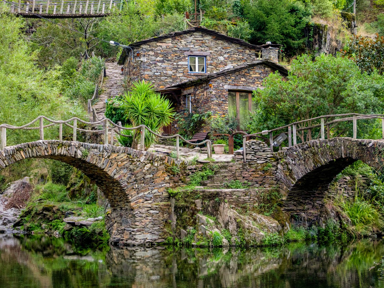 Stone bridges and a traditional house at Foz d'Égua river beach, a secret spot in central Portugal