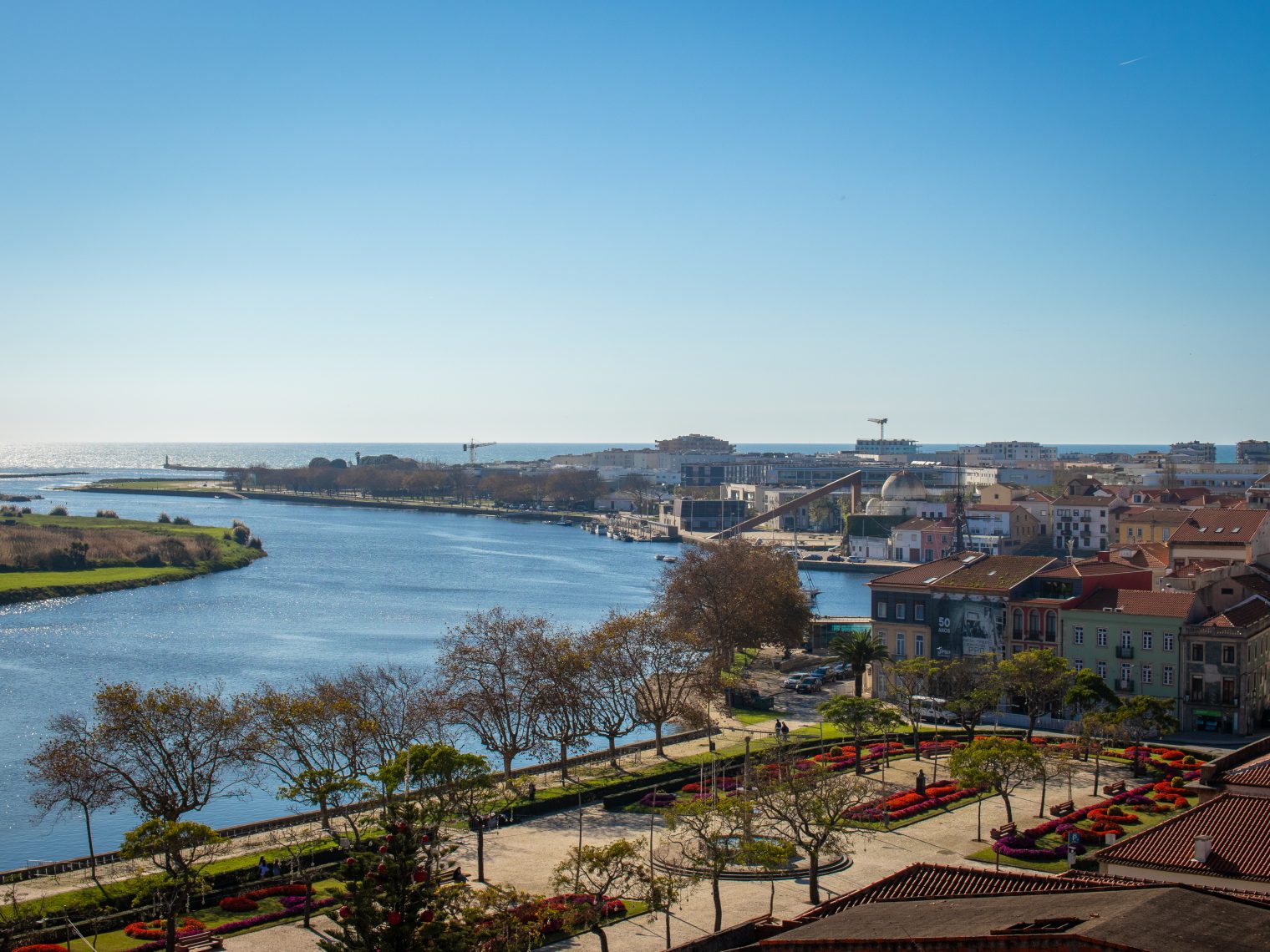 Panoramic view from Santa Clara Monastery of Ave River mouth, colorful gardens, and Vila do Conde cityscape with Atlantic Ocean in background