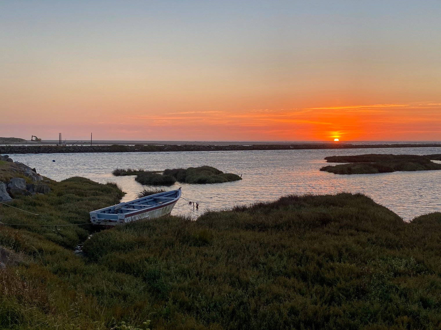 Sunset over Cávado River in Esposende with vintage fishing boat, Northern Portugal